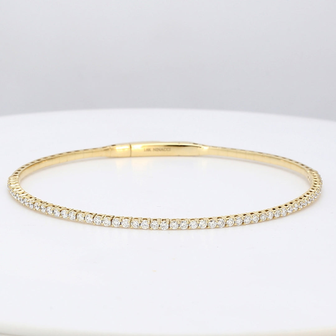 6.5"" Lightweight flexible oval shaped bangle in 18K YG with prong set round diamonds.  D1.02ct.t.w.