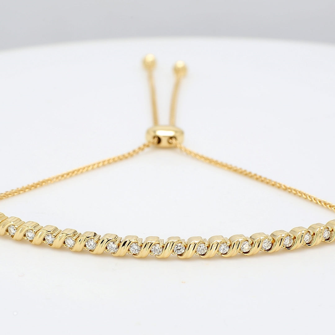 Knot draw string S-style curve bangle in 18K YG with prong set round diamonds.  D0.32ct.t.w.