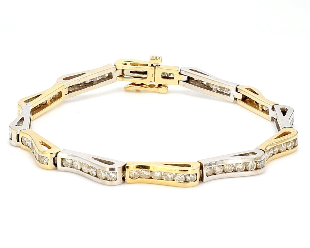Wave design bracelet in two-tone with channel set round diamonds.  D2.50ct.t.w.