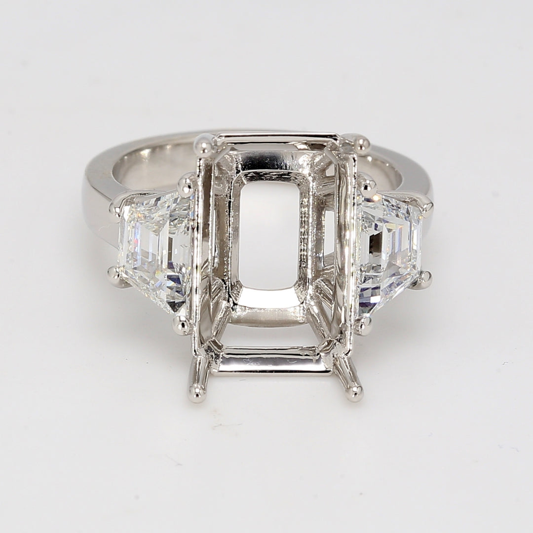 3-stone semi-mount in platinum with step-cut trapezoid diamond sides.  D1.42ct.t.w.