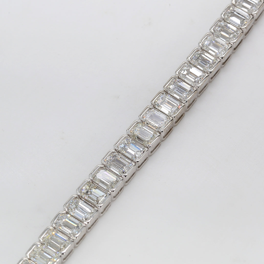 7"" Tennis bracelet in platinum with half bezel set emerald cut diamonds.  D13.58ct.t.w.
