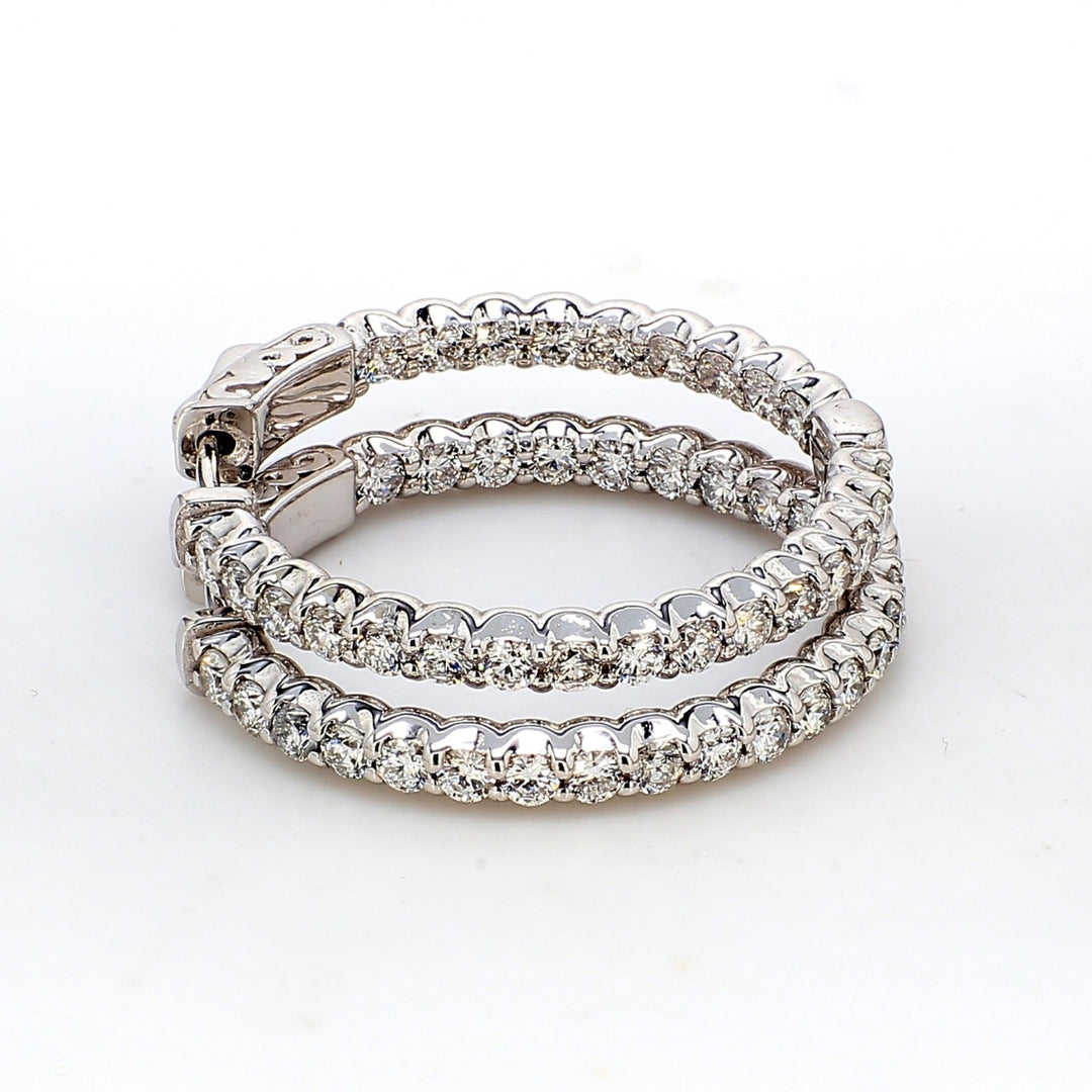 Inside out hoop earrings with shared U-prong set round diamonds.  D1.90ct.t.w.