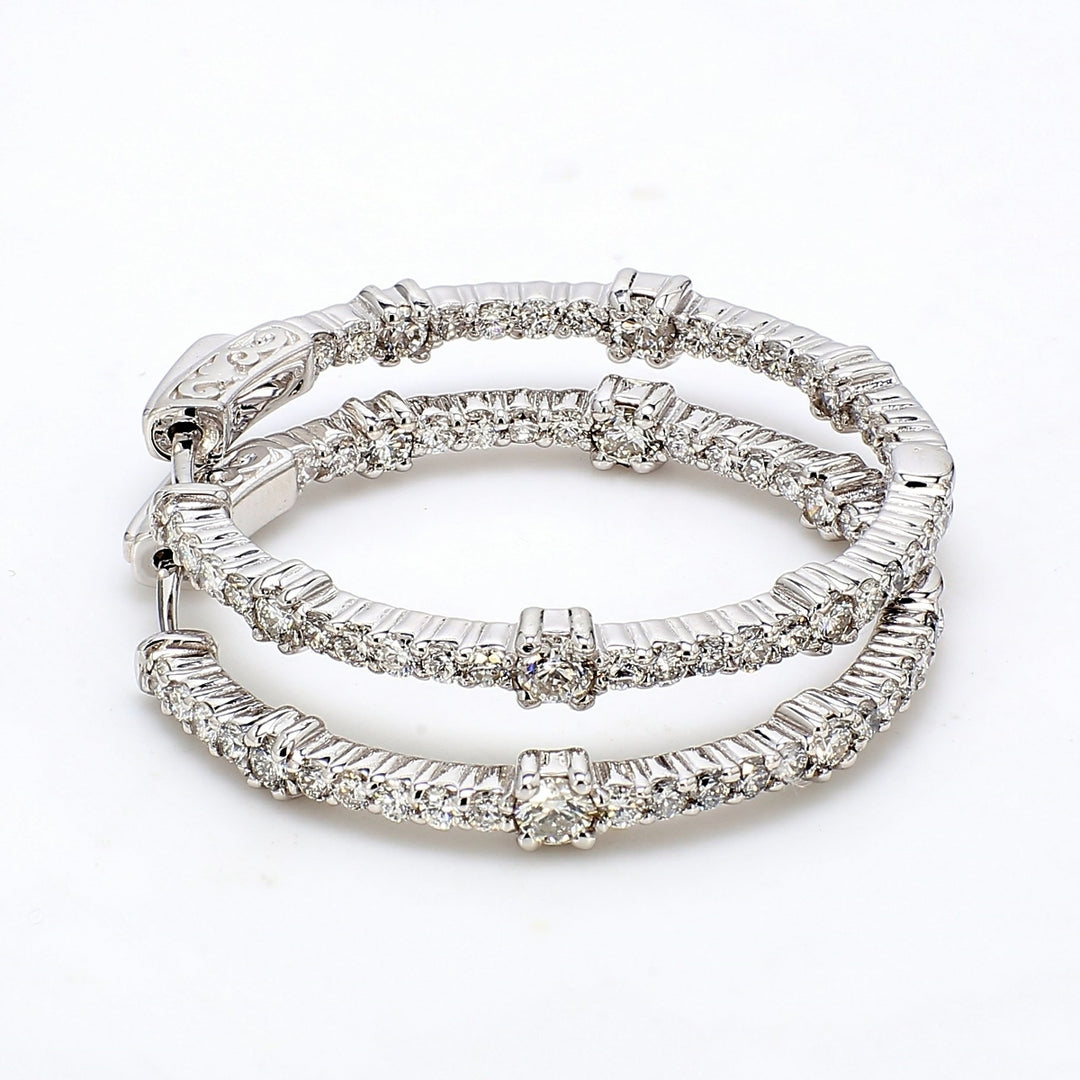 1.25"" Inside out hoop earrings with prong set round diamonds.  D2.07ct.t.w.