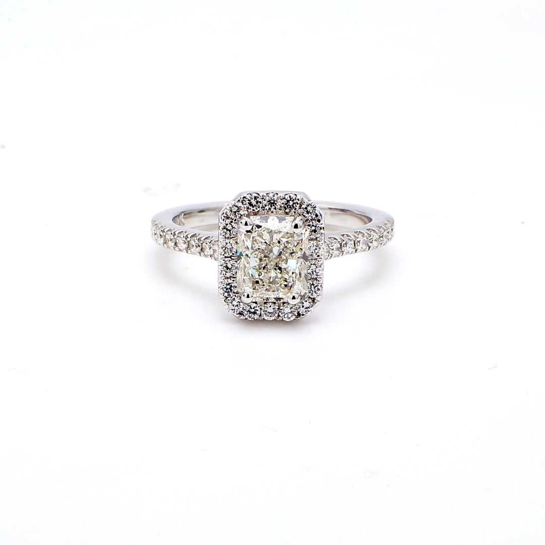 Halo ring with prong set rounds around GIA certified F/SI2 radiant diamond center.  D1.90ct.t.w.  (Center 1.50ct.)  Size 6