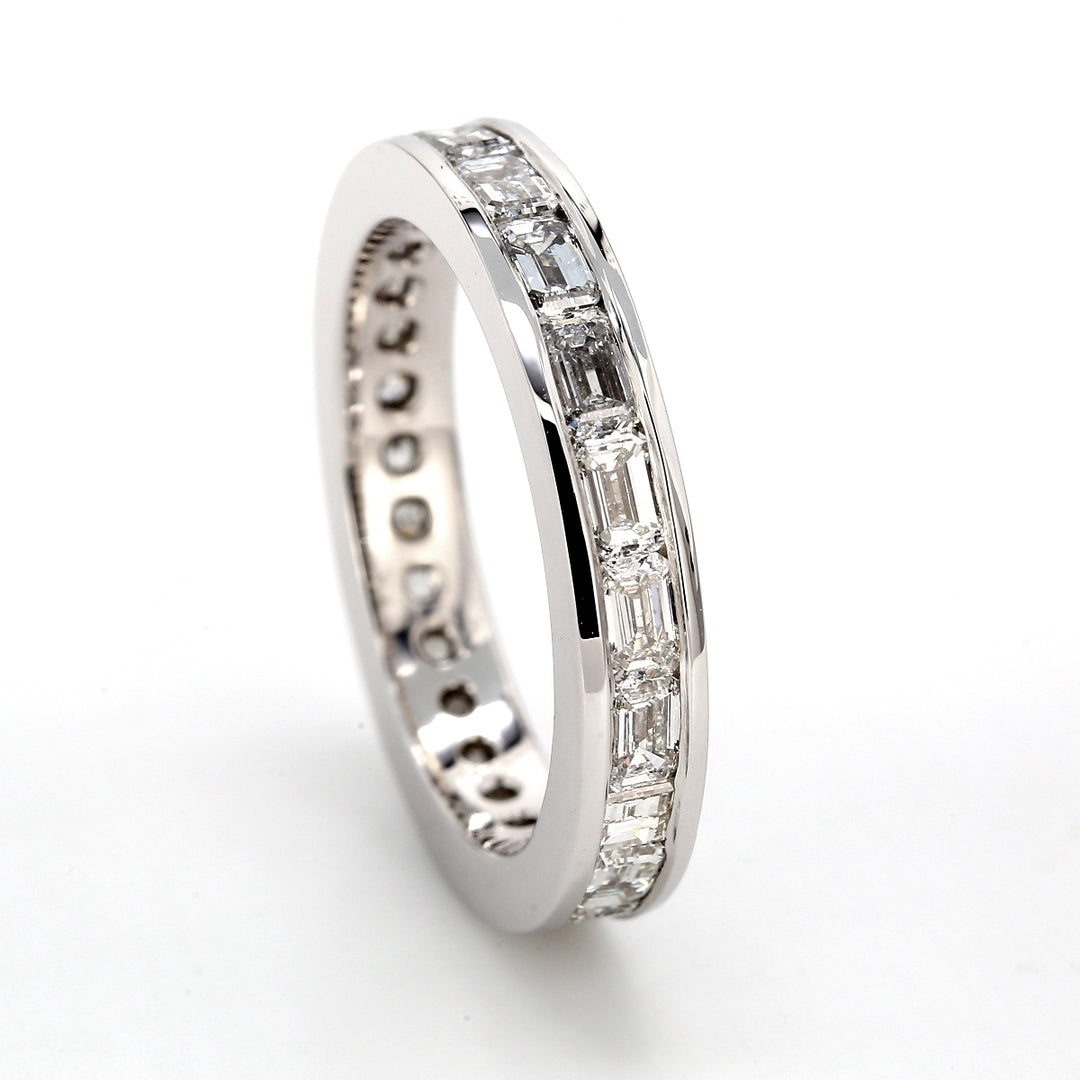 East to west style eternity band with channel set (20) emerald cut diamonds.  D2.32ct.t.w.  Size 6.25