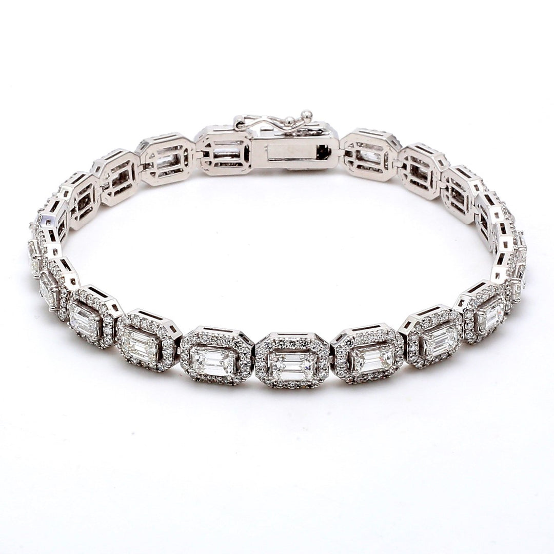 7.5"" Halo tennis bracelet with prong set rounds around prong set emerald cut diamond centers.  D8.13ct.t.w.