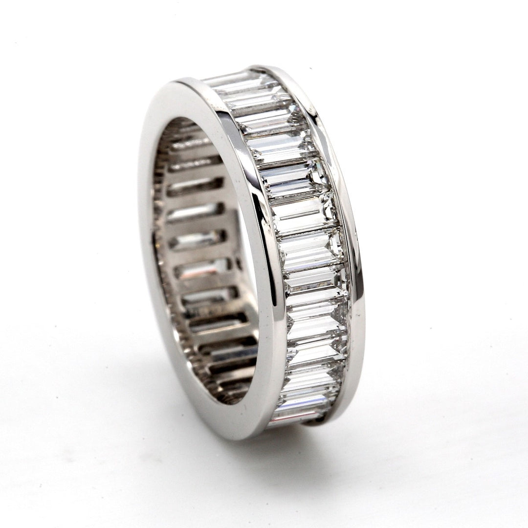 Eternity band in platinum with channel set emerald cut diamonds.  D3.89ct.t.w.
