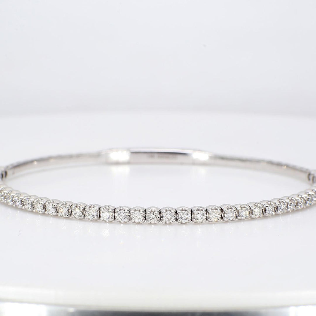 6.5"" Lightweight flexible oval shaped bangle in 18K WG with prong set round diamonds.  D0.88ct.t.w.