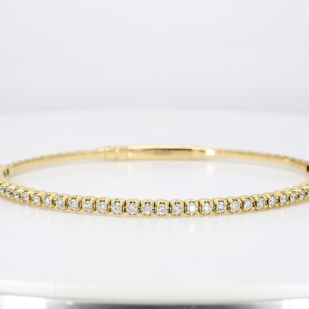 6.25"" Lightweight flexible oval shaped bangle in 18K YG with prong set round diamonds.  D0.88ct.t.w.