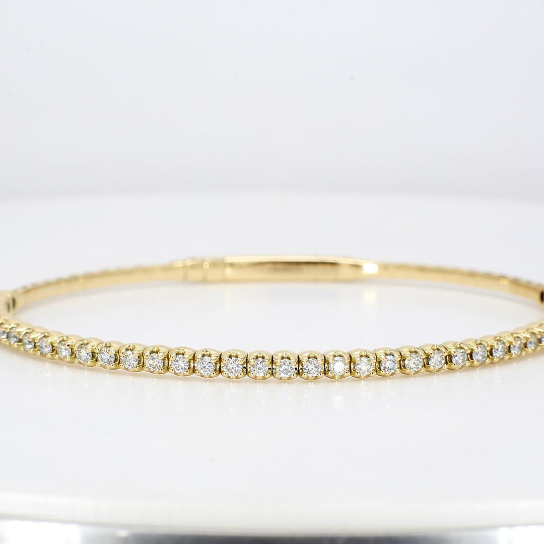 6.75"" Lightweight flexible oval shaped bangle in 18K YG with prong set round diamonds.  D0.88ct.t.w.