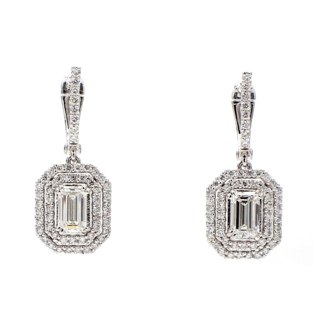 Halo drop earrings with prong set rounds around GIA certified I-J/VVS1 emerald cut diamond centerstones.  D2.95ct.t.w.
