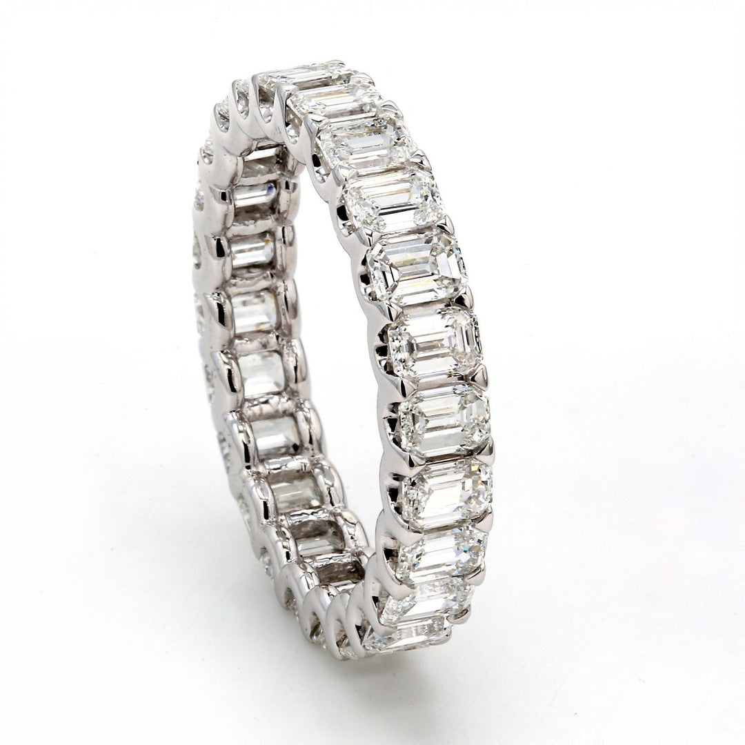 Eternity band with shared U-prong set emerald cut diamonds.  D3.74ct.t.w.