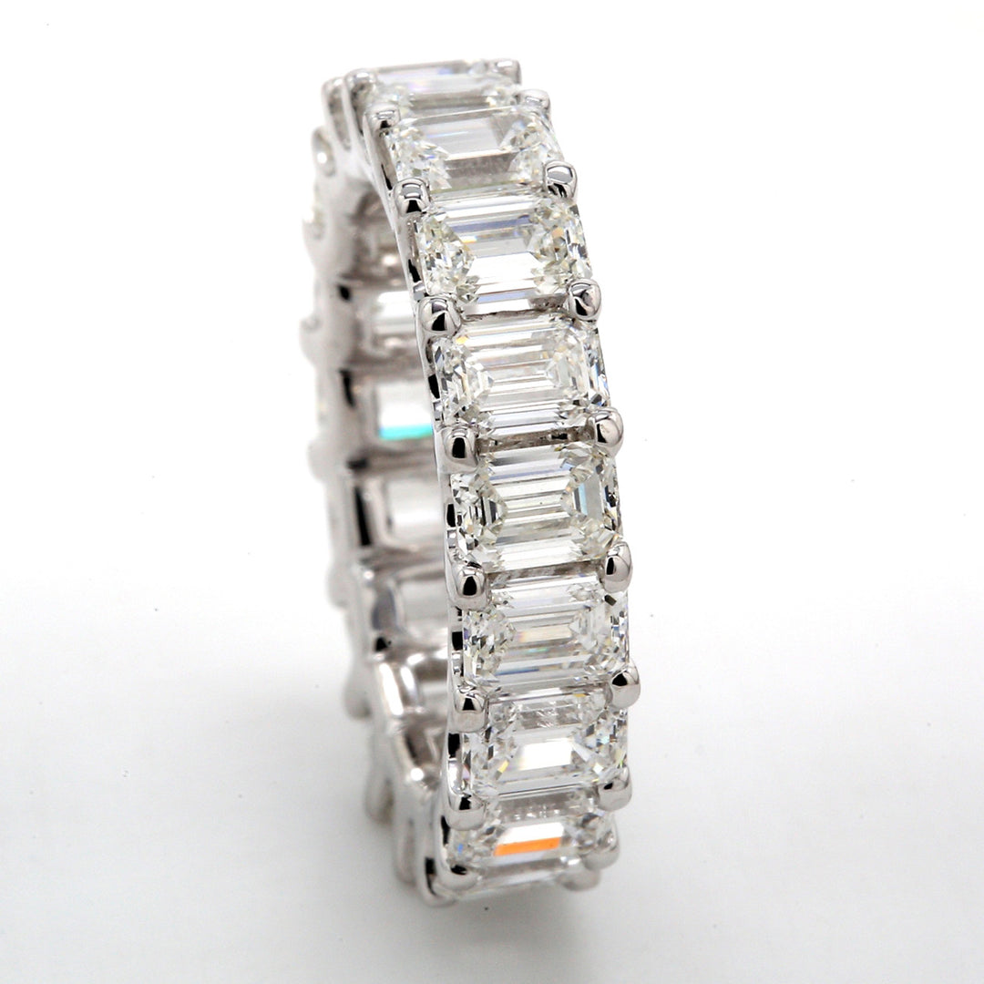 Eternity band with shared U-prong set G-H/VVS emerald cut diamonds.  D5.91ct.t.w.