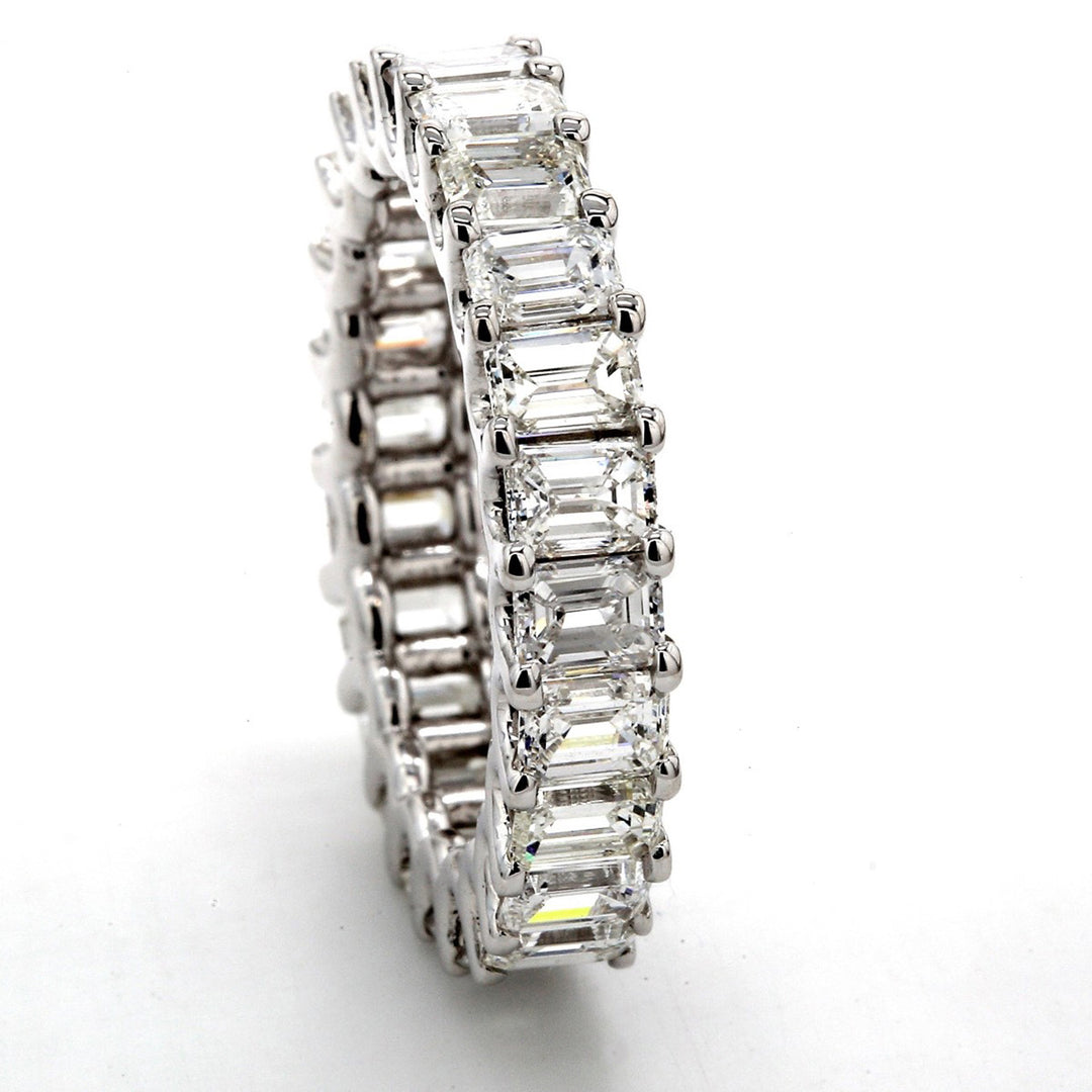 Eternity band in 18K WG with shared U-prong set (24) emerald cut diamonds.  D4.65ct.t.w.