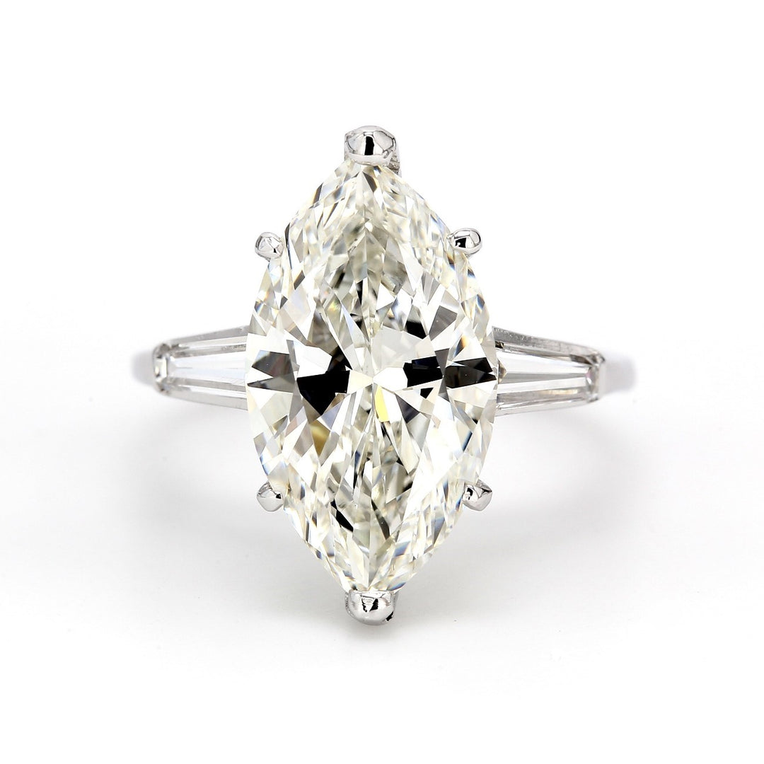 3-stone ring in platinum with GIA certified I/SI2 marquise center and channel set baguette diamond sidestones.  D5.49ct.t.w.  (Center 5.01ct.)