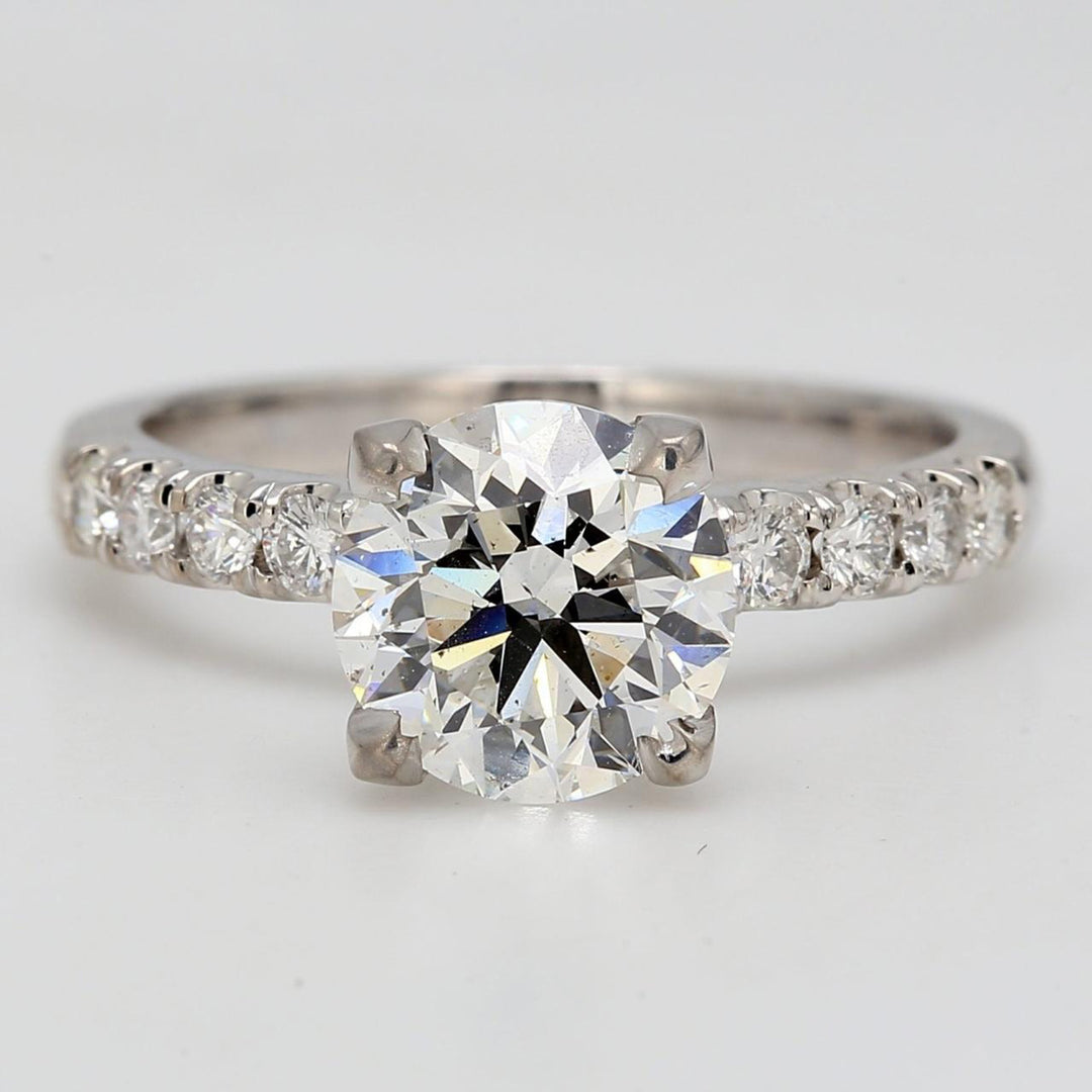 Ring with U-prong set rounds on shank and prong set GIA certified E/SI2 round diamond center.  D2.35ct.t.w.  (Center 2.01ct.)