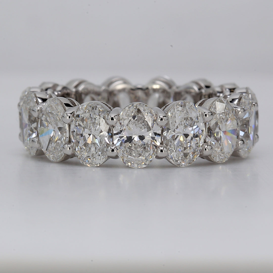 Eternity band in platinum with basket shared prong GIA certified D-F/SI1-SI2 (15) oval diamonds.  D7.71ct.t.w.  Size 6.5