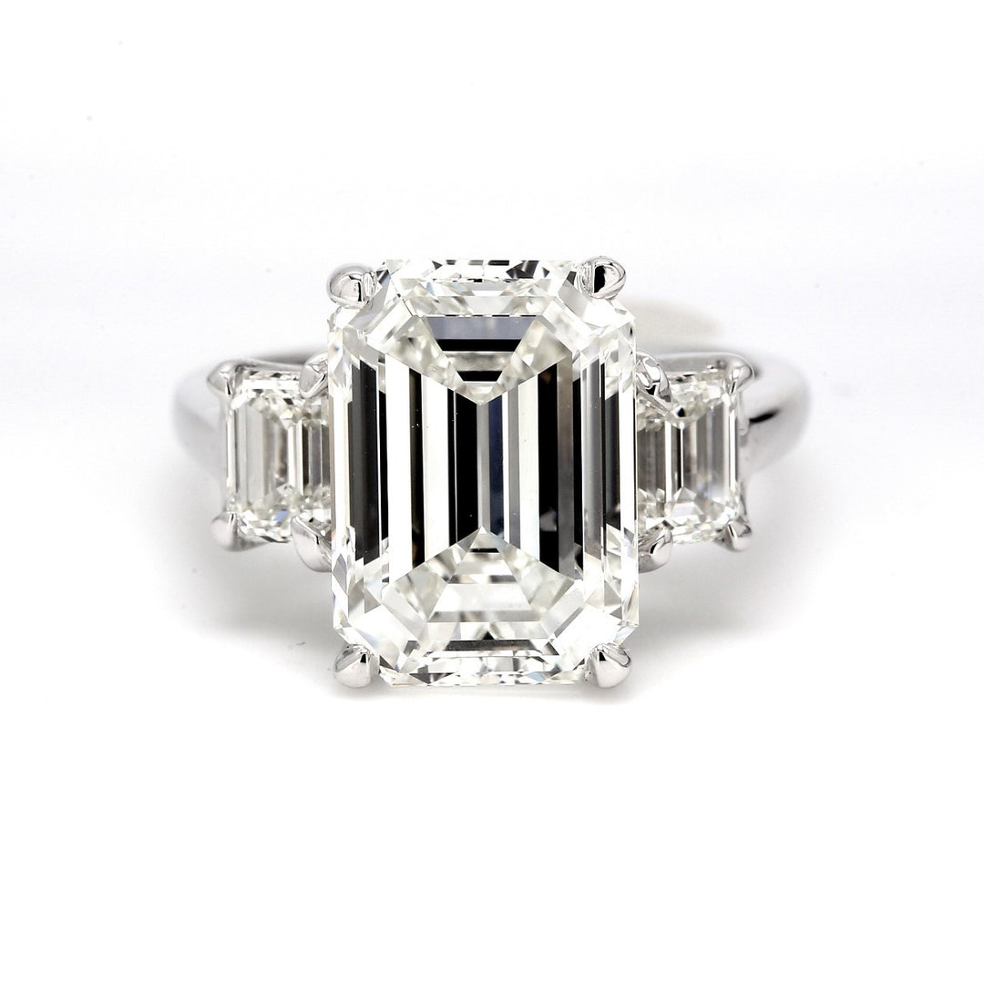 3-stone ring in platinum with GIA certified J/VS2 emerald cut center and 4-prong set J/VS1 emerald diamond sides.  D7.01ct.t.w.  (Center 6.01ct.)