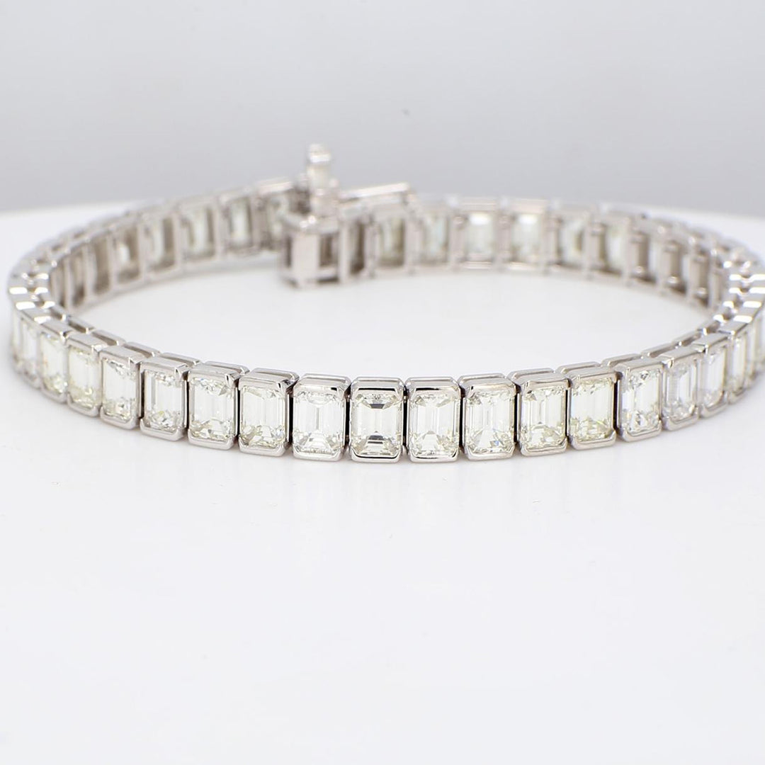 7"" Tennis bracelet in platinum with half bezel set emerald cut diamonds.  D15.40ct.t.w.