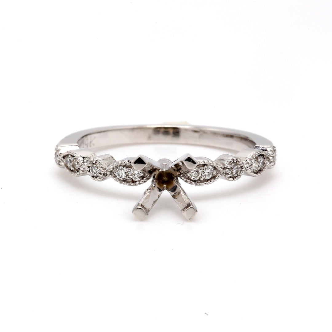 Semi-mount with shared prong set round diamonds.  D0.14ct.t.w.  Size 6.75