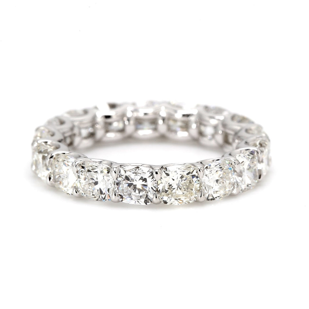 Eternity band in platinum with shared U-prong set cushion cut diamonds.  D5.64ct.t.w.