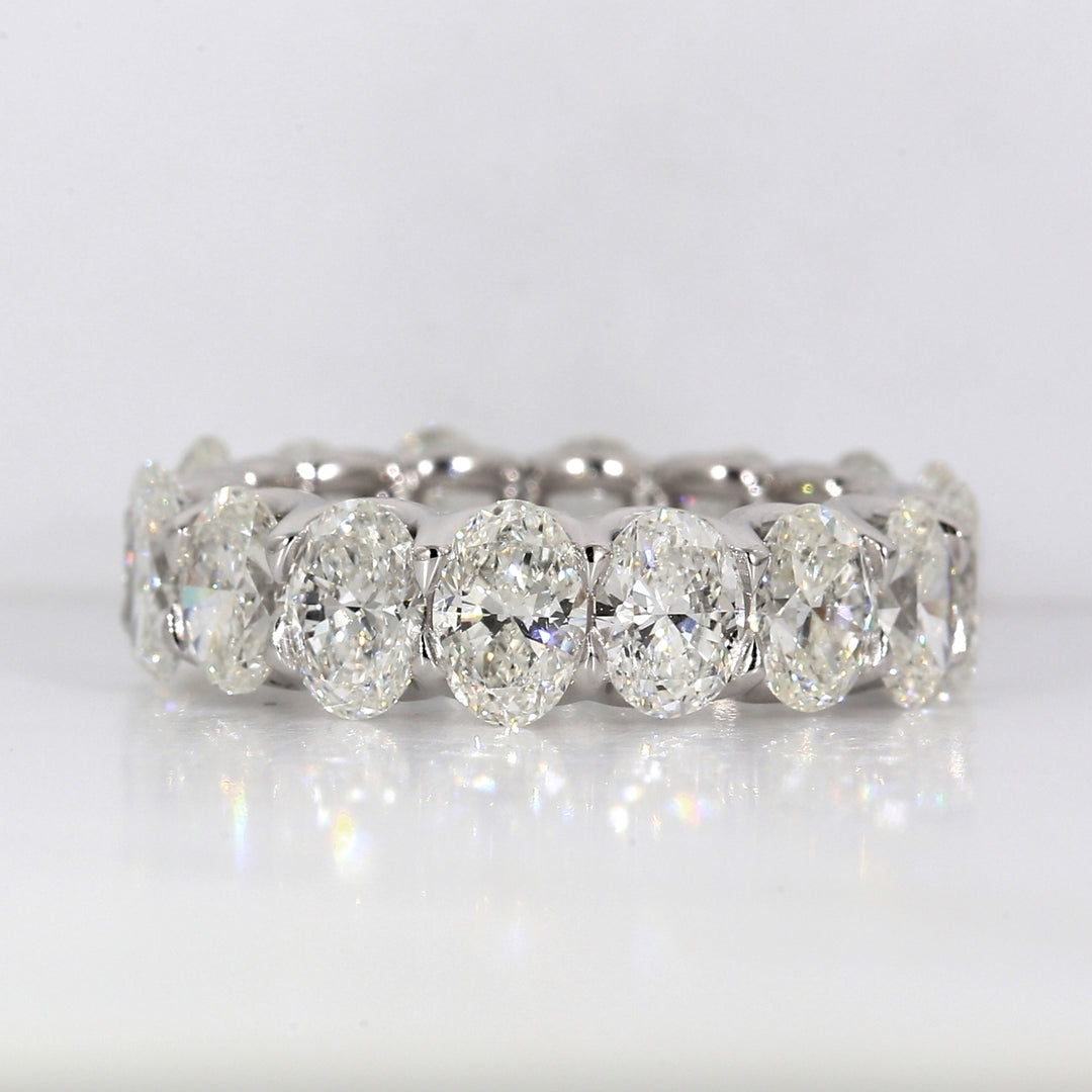 Eternity band in platinum with shared U-prong set GIA certified G-I/VVS2-SI1 (16) oval diamonds.  D6.48ct.t.w.  Size 6