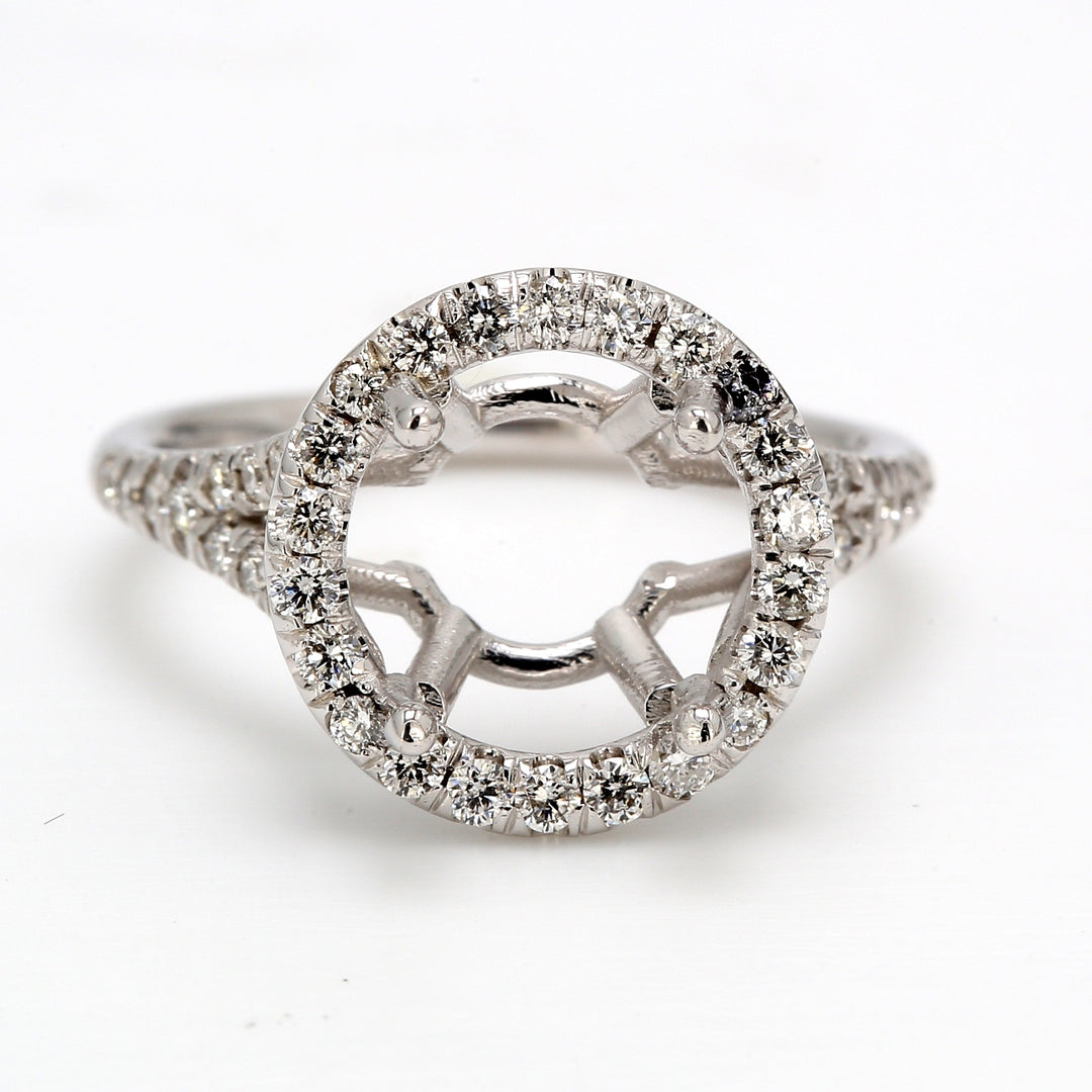 Halo split shank semi-mount with shared prong set round diamonds.  D0.45ct.t.w.