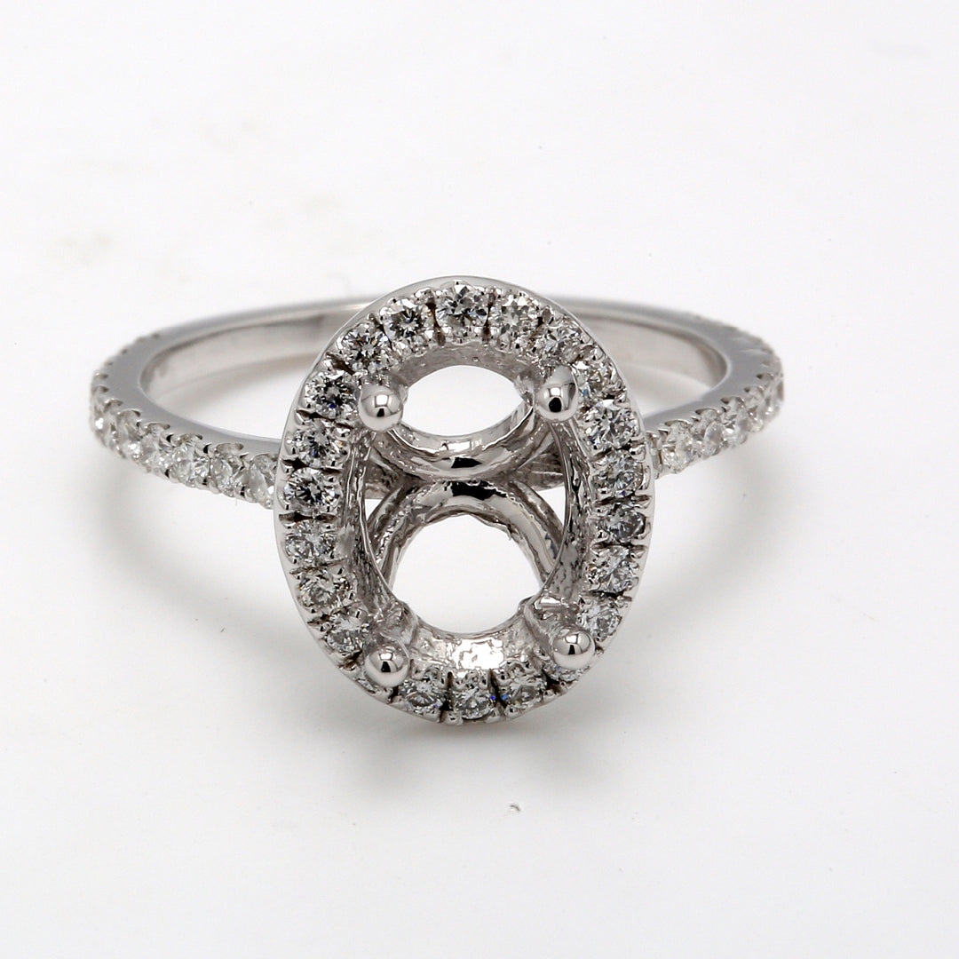 Halo semi-mount with U-prong set round diamonds.  D0.62ct.t.w.  Size 7