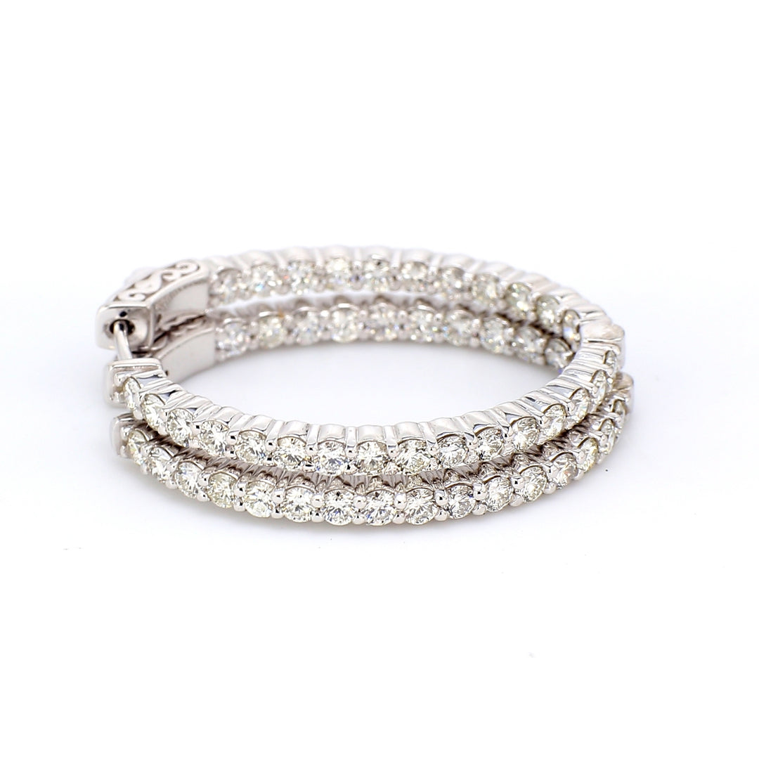1.25"" Oval shaped inside out hoop earrings with shared prong set (54) round diamonds & with special spring lock.  D2.59ct.t.w.