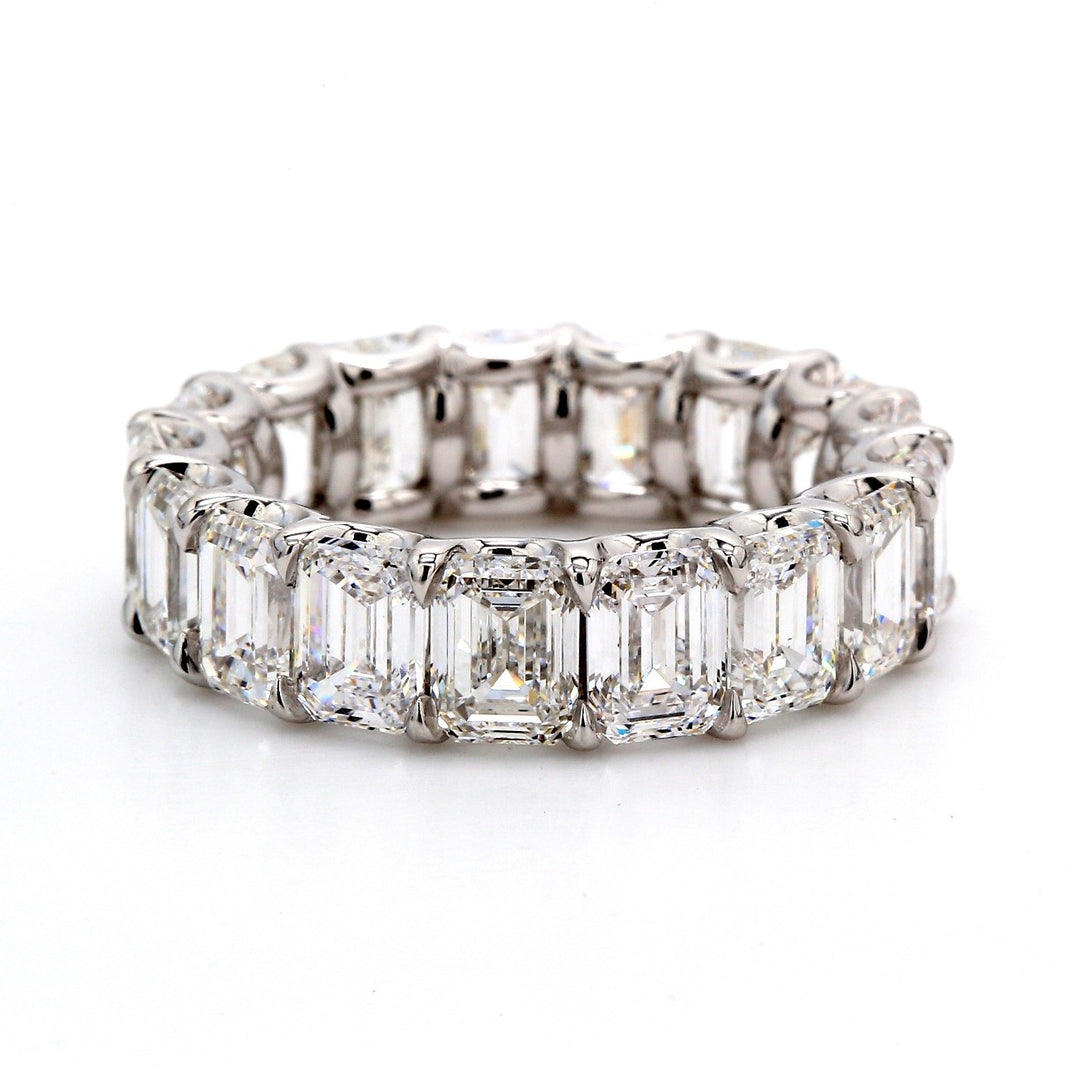 Eternity band in platinum with shared claw prong set GIA certified D-F/VVS1-VS2 emerald cut diamonds.  D8.71ct.t.w.  Size 6.25