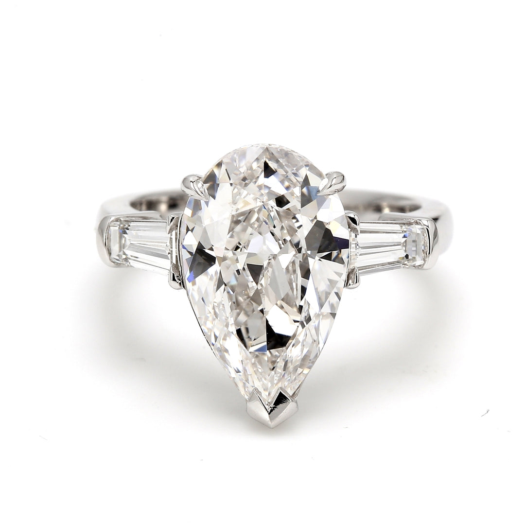 3-stone semi-mount in platinum with channel set tapered baguette diamond sides.  D0.58ct.t.w.  Size 5.5
