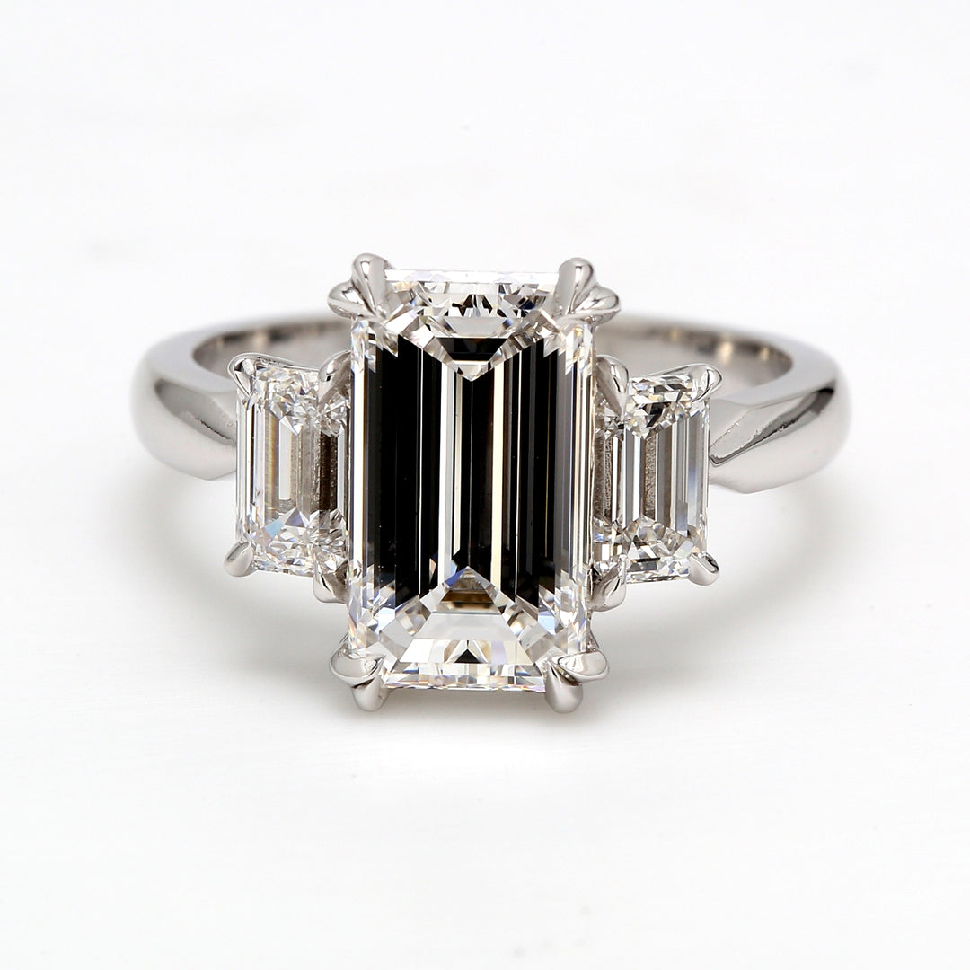 3-stone semi-mount in platinum with 4-prong set GIA certified D/VVS-VS2 emerald cut diamond sides.  D1.02ct.t.w.  Size 6.5