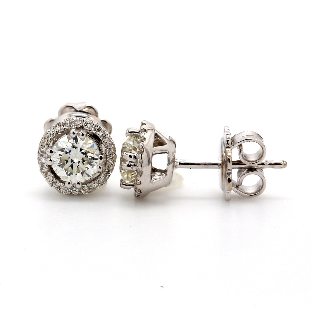 Halo pushback stud earrings with prong set rounds around double 4-prong round diamond centers.  D1.02ct.t.w.  (Centers 0.87ct.t.w.)