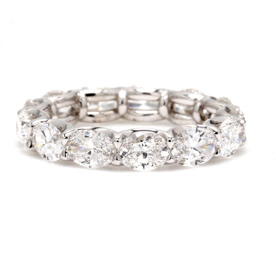 East to west style eternity band in platinum with shared U-prong set oval diamonds.  D3.73ct.t.w.  Size 6