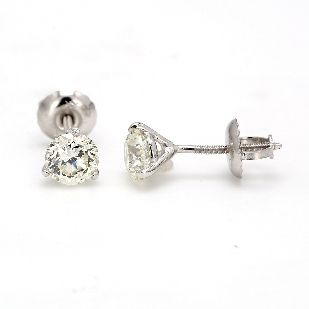 Screw back stud earrings with 3-prong set round diamonds.  D0.93ct.t.w.