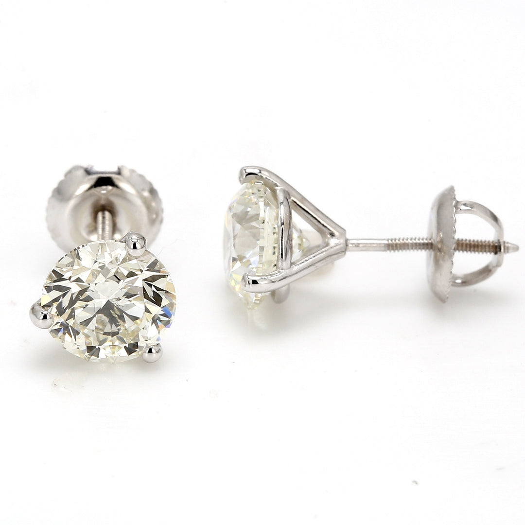 Screw back martini style stud earrings with 3-prong set round diamonds.  D3.01ct.t.w.