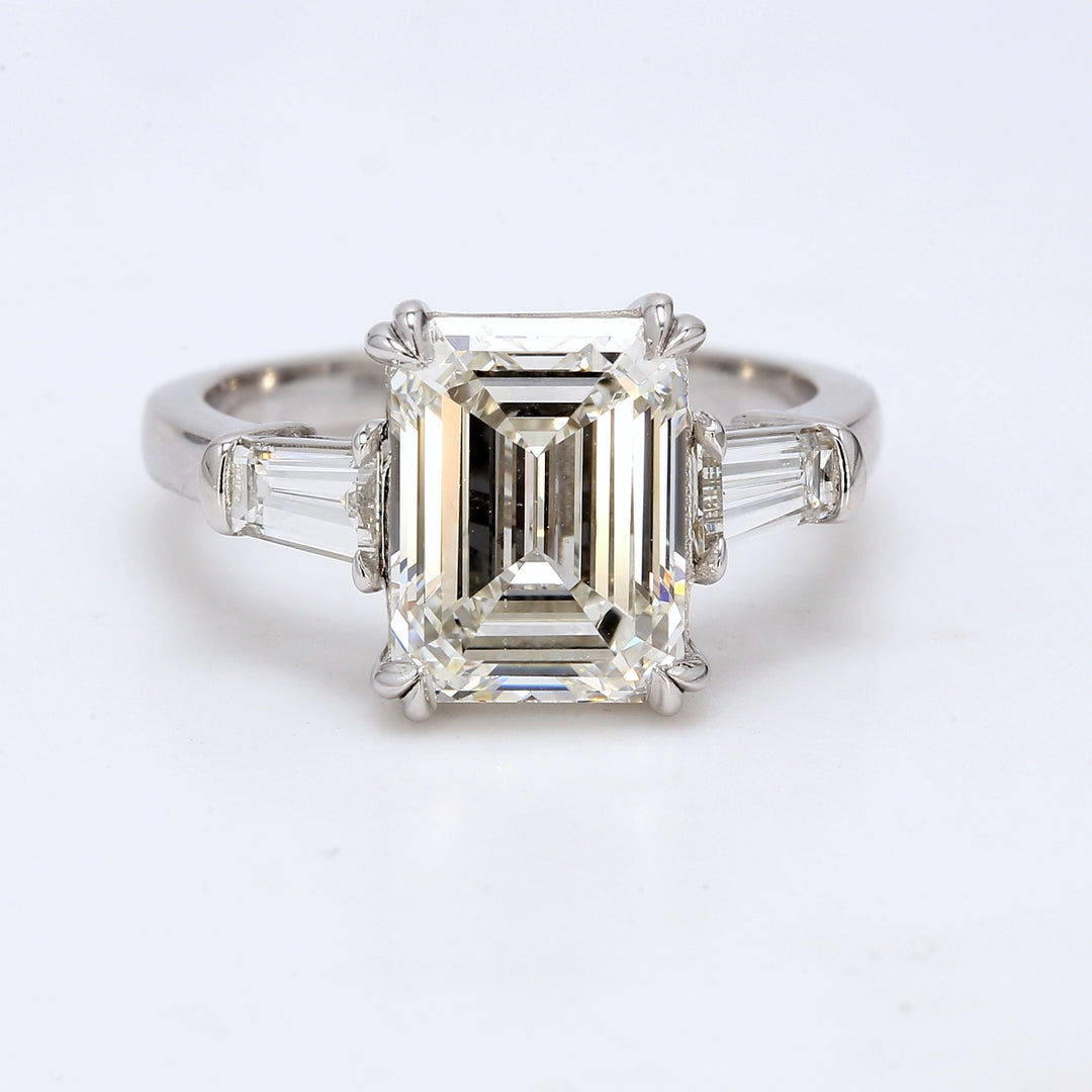 3-stone semi-mount in platinum with prong set tapered baguette diamond sides.  D0.63ct.t.w.