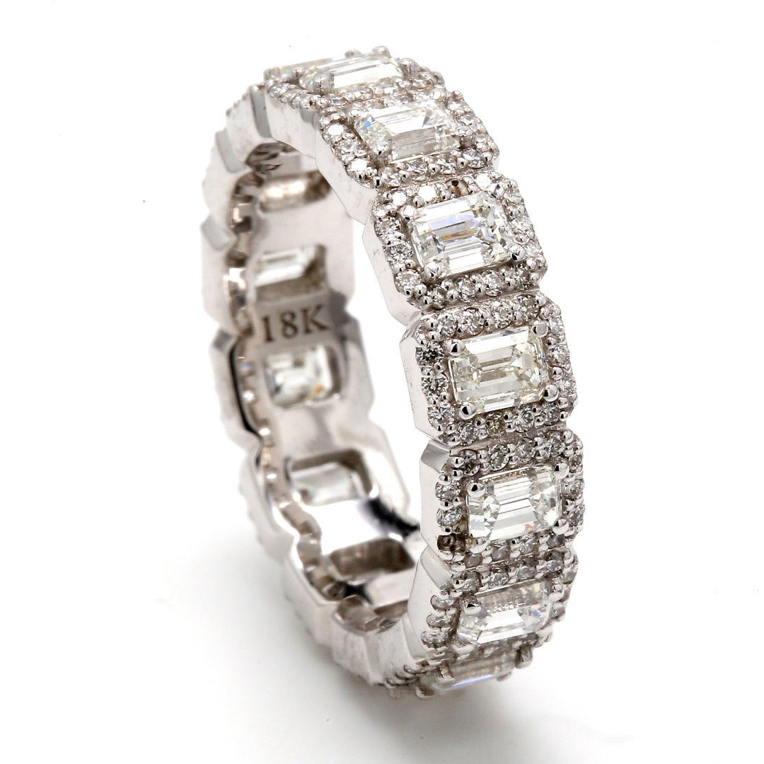 Halo eternity band with pave set round diamond around 4-prong set (14) emerald cut diamonds.  D3.56ct.t.w.  Size 8