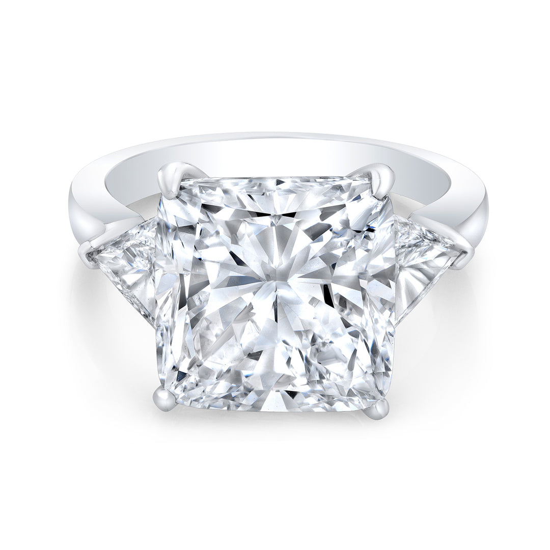 3-stone ring in platinum with GIA certified G/SI2 cushion cut center and trilliant cut diamond sides.  D11.56ct.t.w.  (Center 10.29ct.)