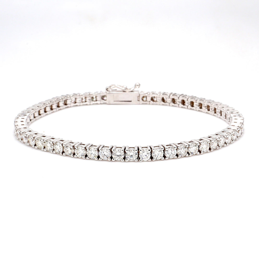 7"" Tennis bracelet in 18K WG with 4-prong set (55) round diamonds.  D6.05ct.t.w.