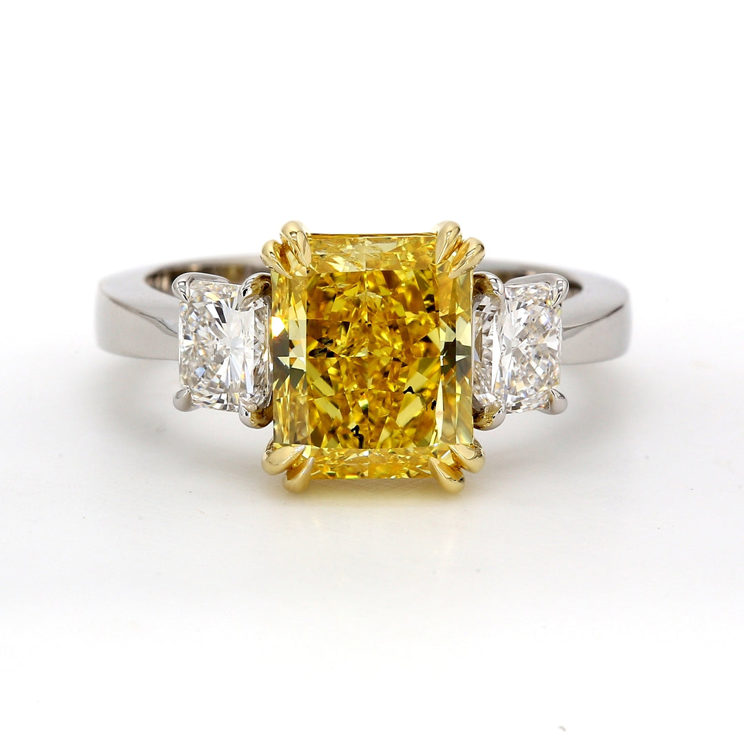 3-stone ring in 18K and platinum with GIA certified FVY/SI2 radiant cut center & radiant cut diamond sides.  D4.03ct.t.w.  (Center 3.00ct.)