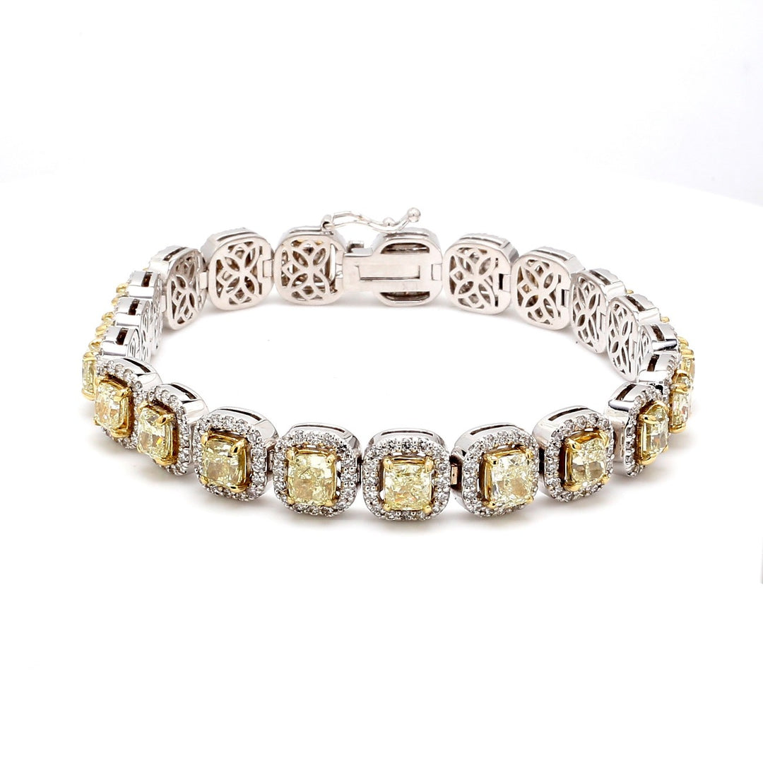 7"" Halo tennis bracelet in 18K WG with prong set rounds around and 4-prong set fancy yellow cushion diamond centers.  D14.75ct.t.w.