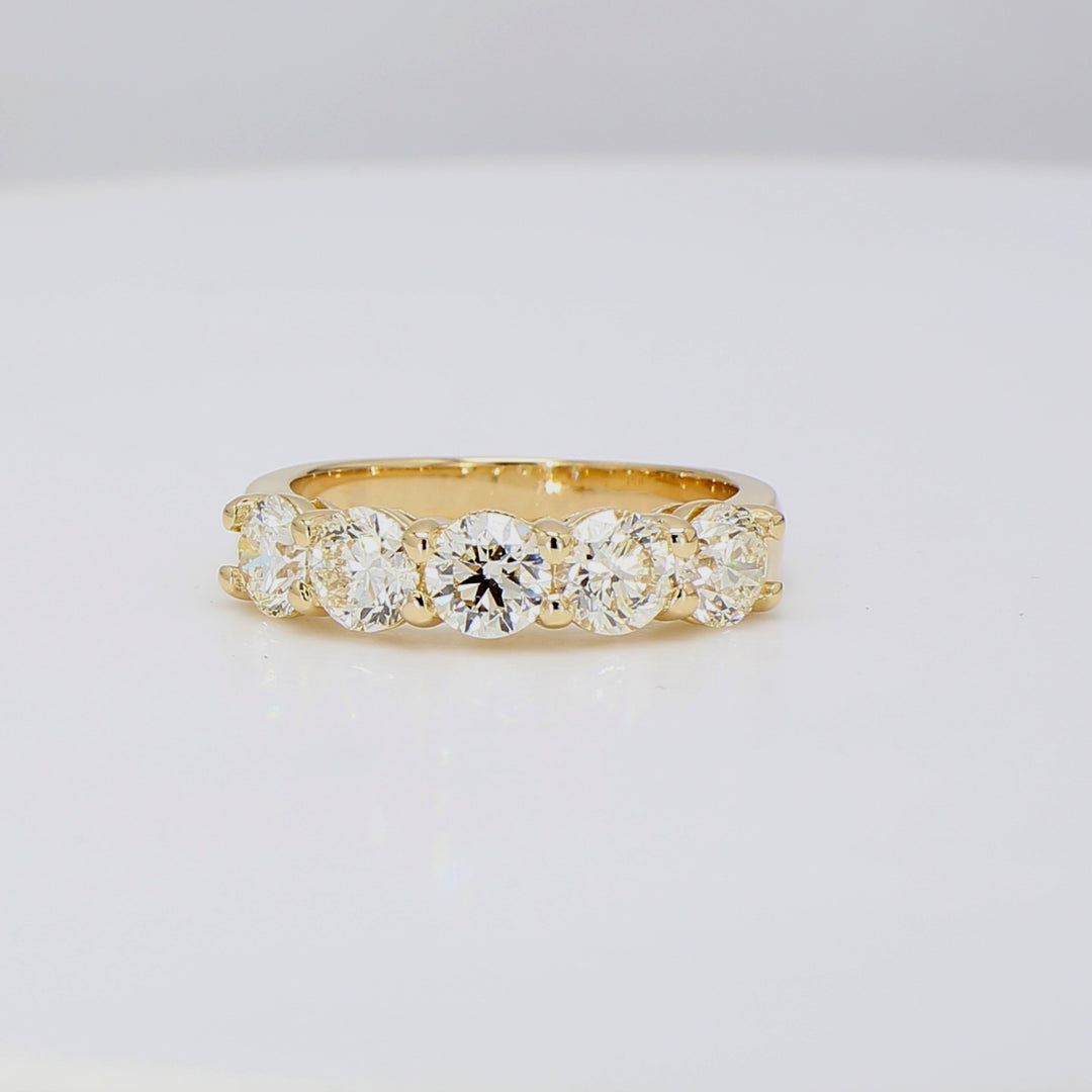 5-stone band in yellow gold with shared prong set round diamonds.  D1.98ct.t.w.