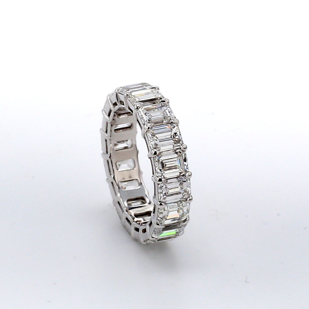 Eternity band in platinum with shared prong set (19) emerald cut diamonds.  D5.58ct.t.w.  Size 4.75