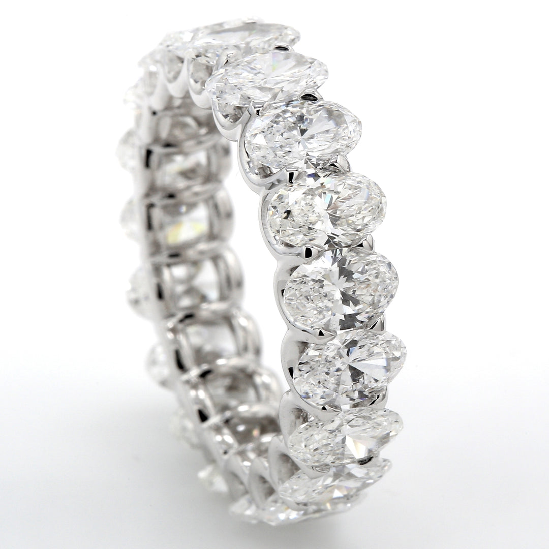 Eternity band in platinum with shared U-prong set (19) oval diamonds.  D6.16ct.t.w.  Size 7.25