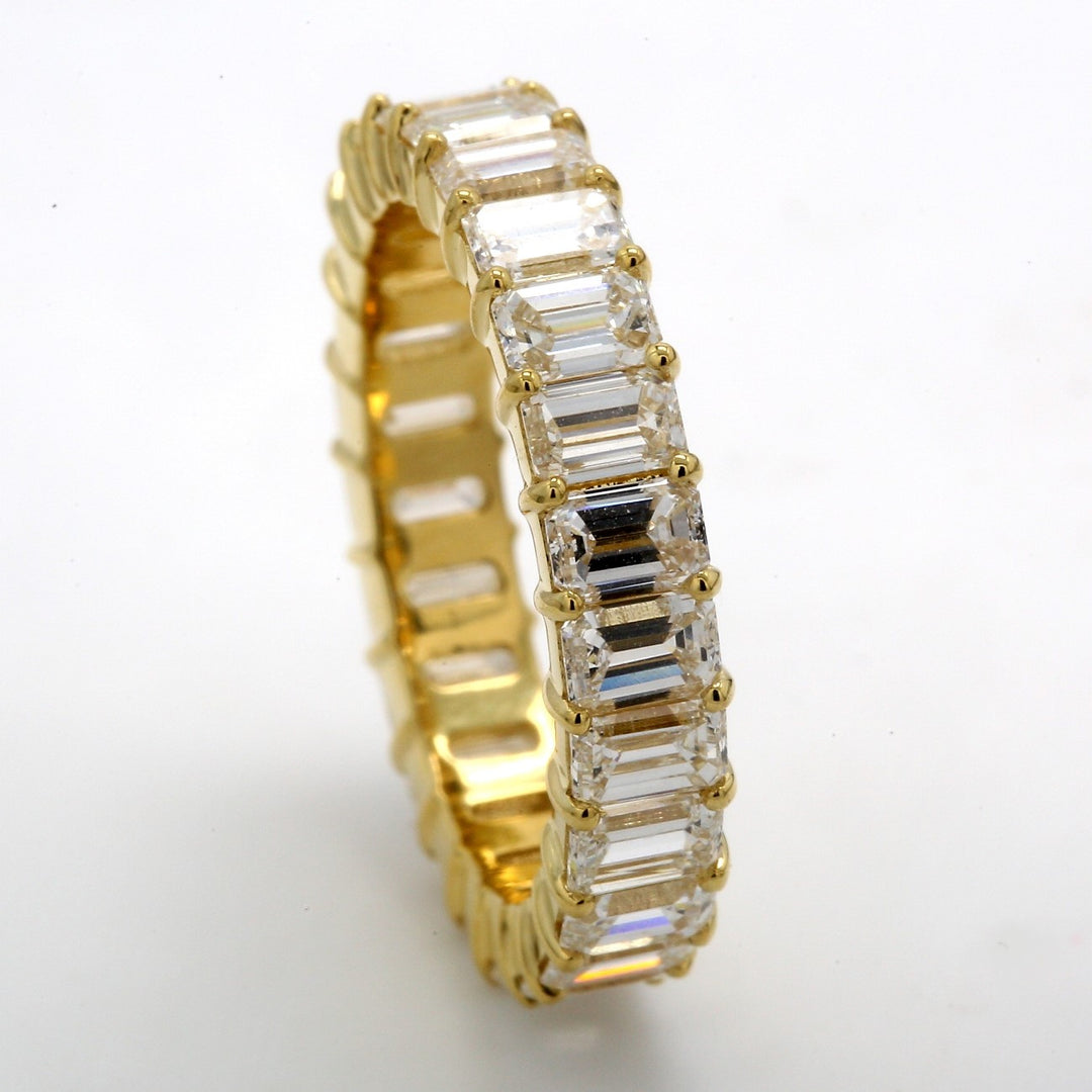 Eternity band in 18K YG with prong set (25) emerald cut diamonds.  D4.79ct.t.w.  Size 7.5