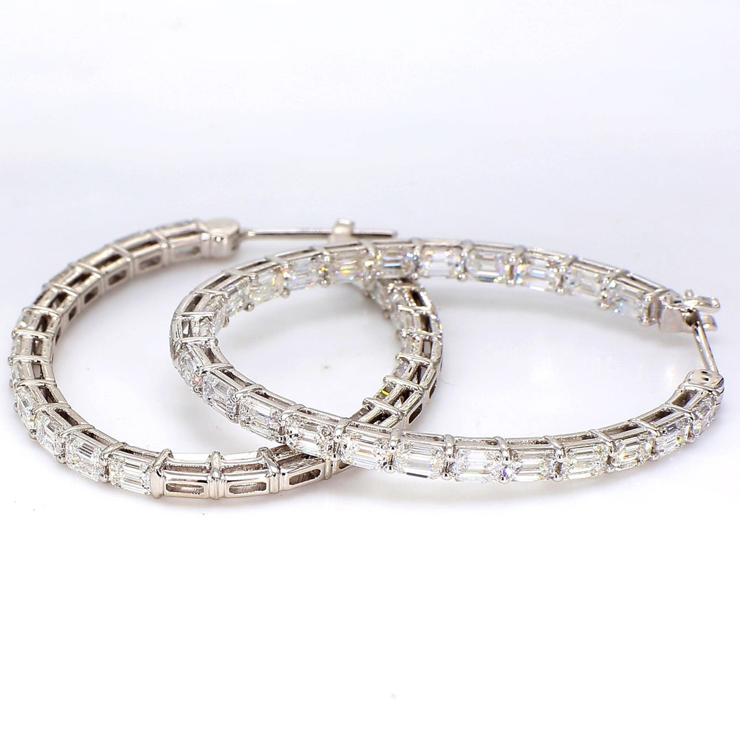 1.5"" Oval shaped inside out hoop earrings in 18K WG with shared prong set emerald cut diamonds.  D6.74ct.t.w.