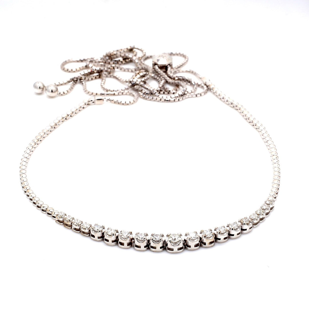 Bolo style adjustable graduated tennis necklace with illusion head 4-prong set (21) round diamonds.  D1.19ct.t.w.