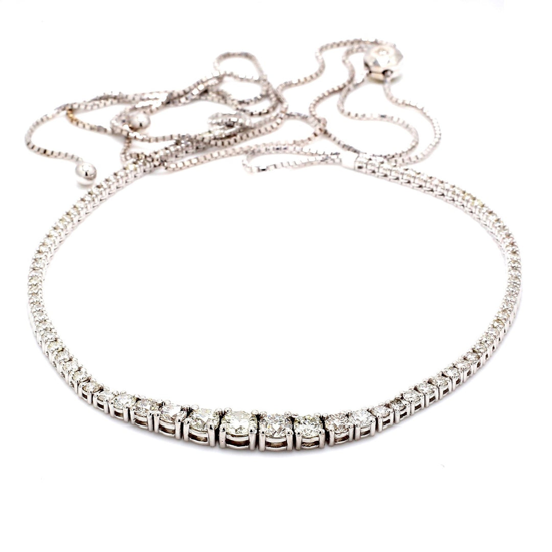 Bolo style adjustable graduated tennis necklace with 4-prong set (85) round diamonds.  D5.29ct.t.w.