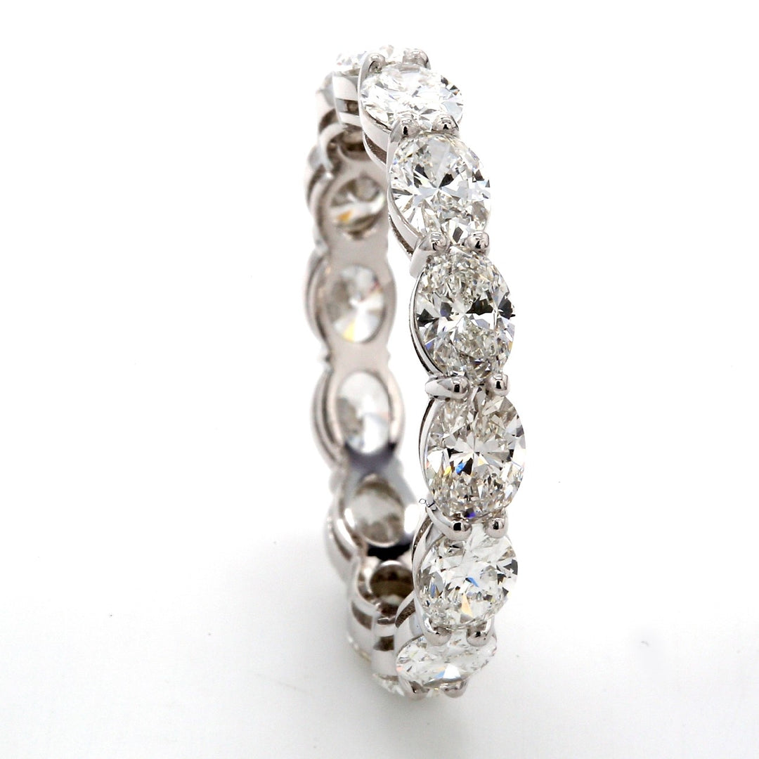 East to west style eternity band in platinum with prong set (14) oval diamonds.  D2.94ct.t.w.